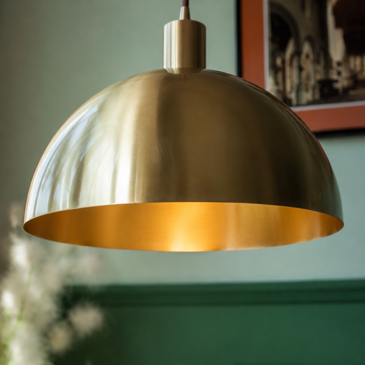 Close view of rolled brass shade edge and brushed texture